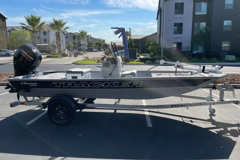 The Image of 2027 Tracker Bass Tracker Classic CC boat on trailer in parking lot. - 0