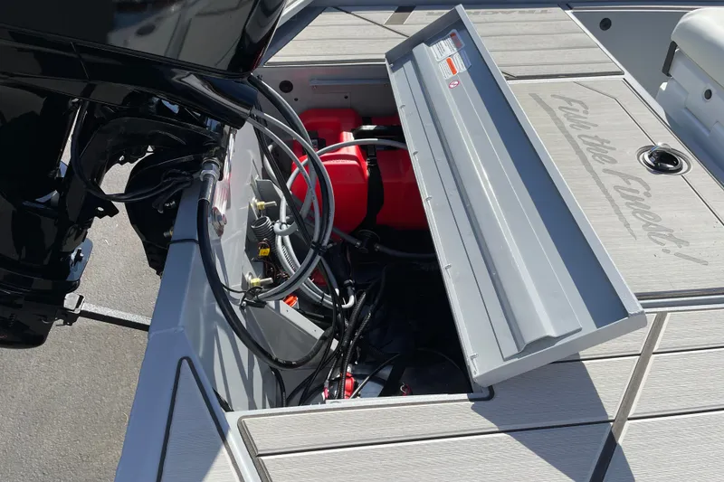 Slide: The Image of 2027 Tracker Bass Tracker Classic CC boat engine compartment with open hatch and visible wiring. - 16