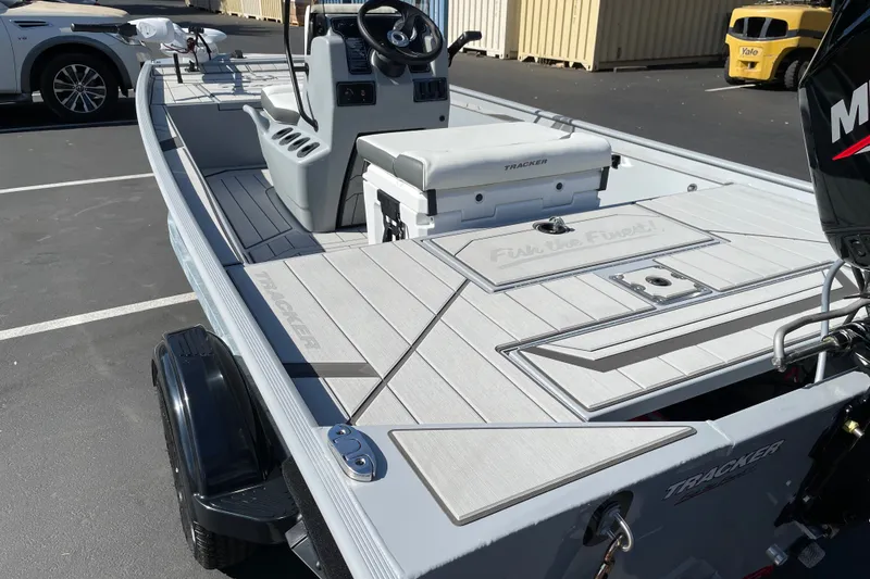 Slide: The Image of 2027 Tracker Bass Tracker Classic CC boat with sleek deck design in a parking lot. - 17