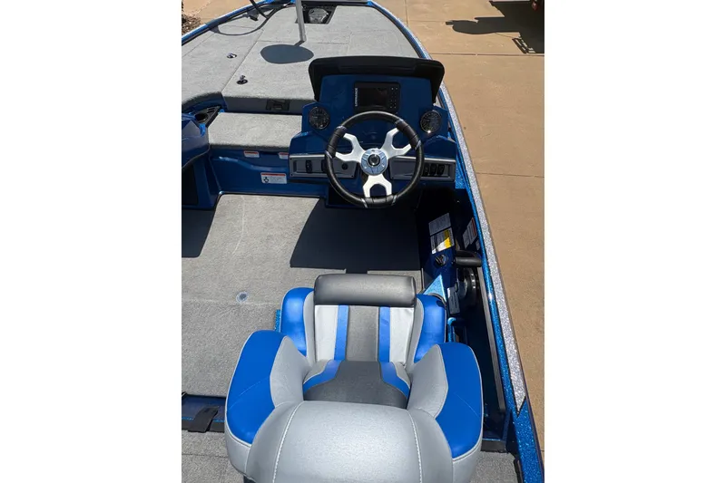 Slide: The Image of 2027 Nitro Z18 XL boat interior with blue and gray seating, steering wheel, and dashboard. - 11