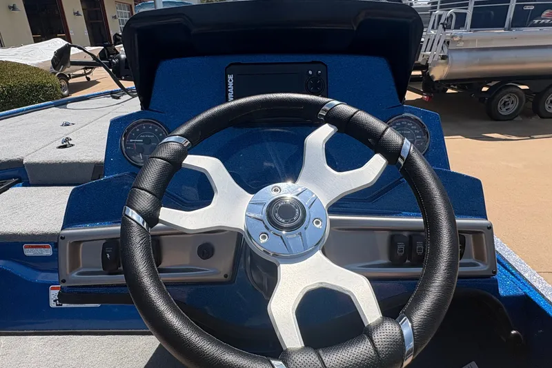 Slide: The Image of Steering wheel of a 2027 Nitro Z18 XL boat, featuring modern dashboard controls. - 19