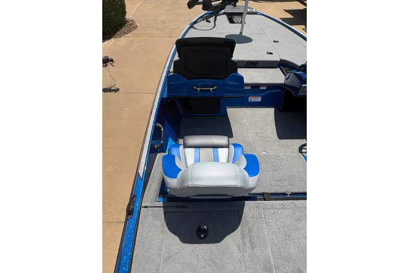 Slide: The Image of 2027 Nitro Z18 XL boat interior with blue and gray seating, carpeted deck, and storage compartments. - 16