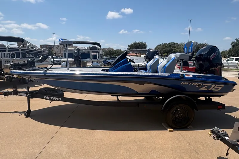 Slide: The Image of 2027 Nitro Z18 XL boat in a dealership lot under a clear blue sky. - 3