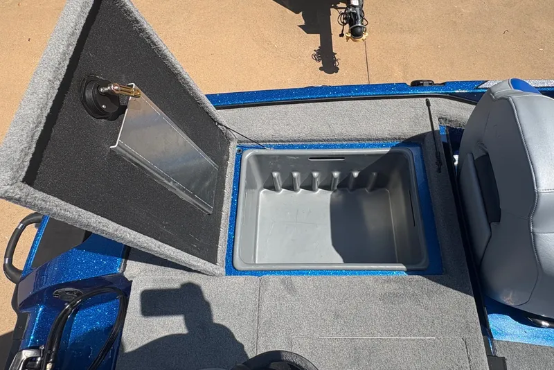Slide: The Image of Open storage compartment in a 2027 Nitro Z18 XL boat, featuring a gray interior. - 14