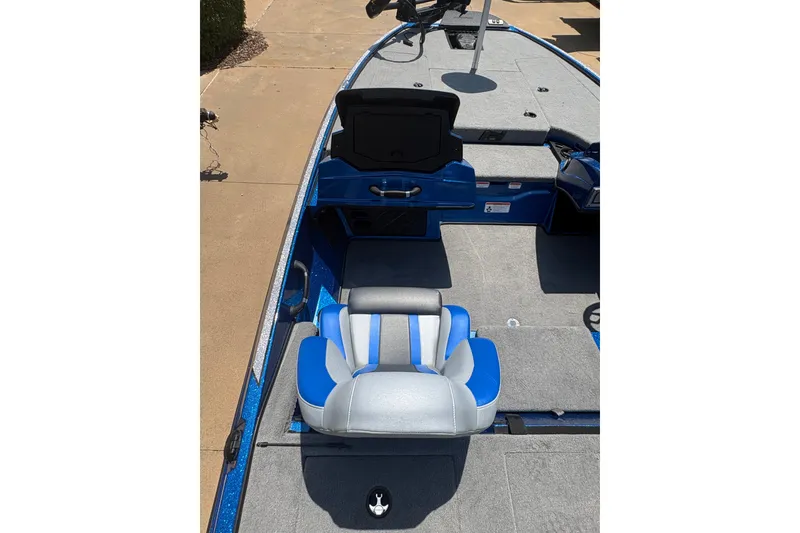 Slide: The Image of 2027 Nitro Z18 XL boat interior with blue and gray seating, open storage compartment. - 12