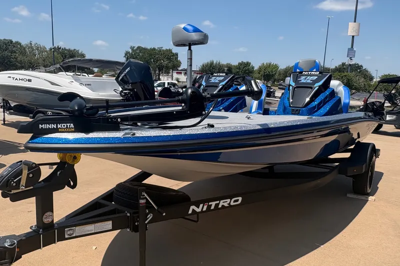 Slide: The Image of 2027 Nitro Z18 XL boat with Minn Kota motor on trailer in outdoor showroom. - 1