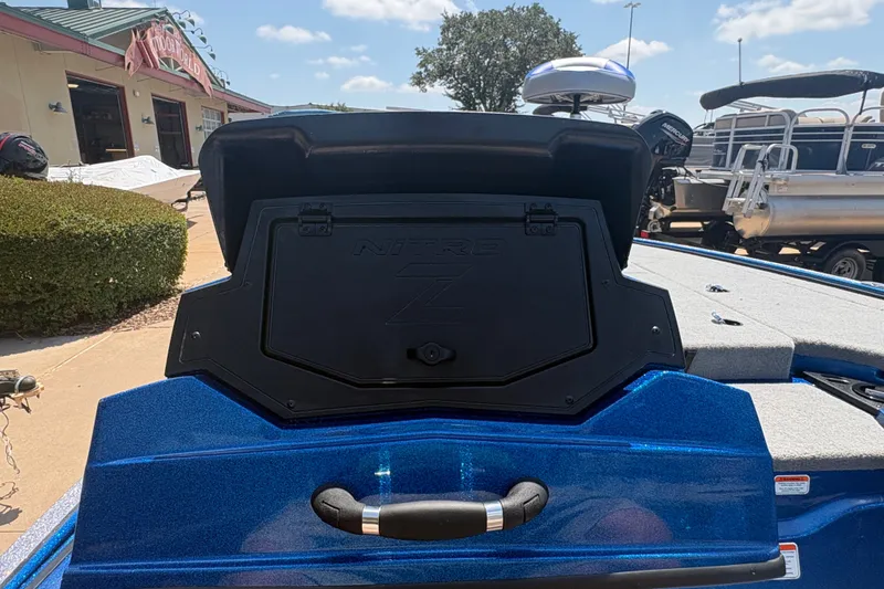 Slide: The Image of 2027 Nitro Z18 XL boat with open storage compartment, blue exterior, outdoor setting. - 17