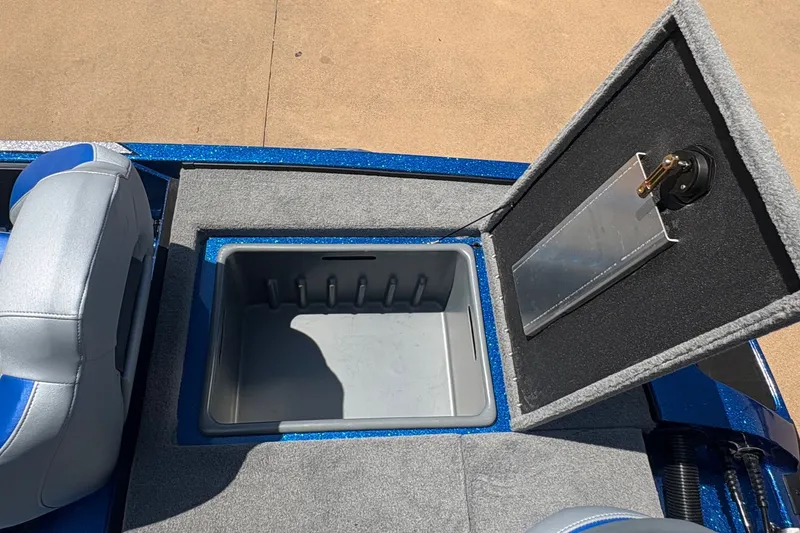 Slide: The Image of 2027 Nitro Z18 XL boat interior with open storage compartment and blue-gray seating. - 15