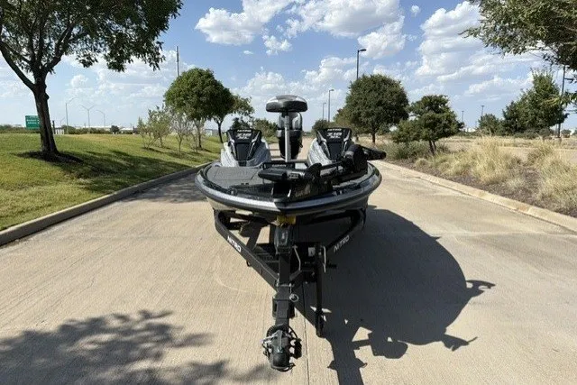 Slide: The Image of 2027 Nitro Z18 XL Pro boat on a sunny road with trees and clouds. - 5