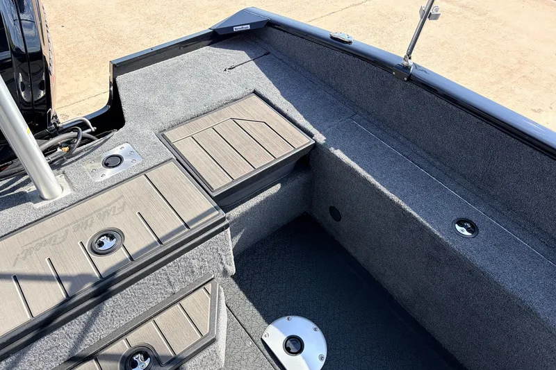 Slide: The Image of 2027 Tracker Pro Guide V-175 Combo boat interior with carpeted flooring and storage compartments. - 38