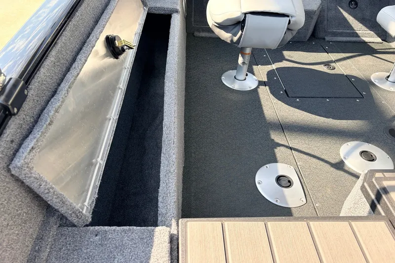 Slide: The Image of Interior view of 2027 Tracker Pro Guide V-175 Combo boat, featuring seating and storage compartments. - 46