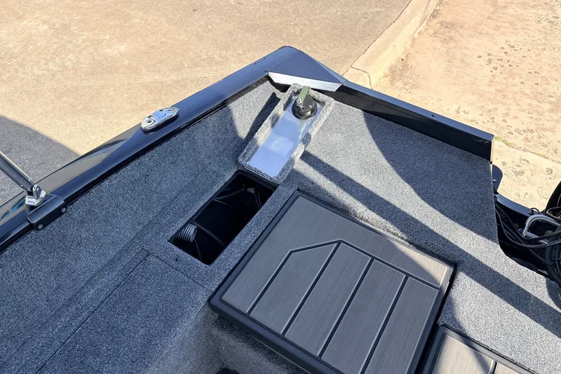 Slide: The Image of 2027 Tracker Pro Guide V-175 Combo boat interior with carpeted deck and storage compartments. - 51