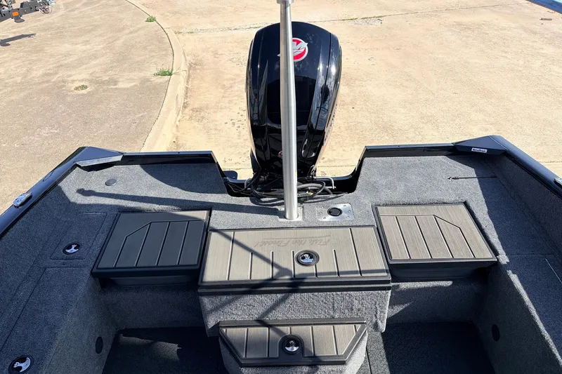 Slide: The Image of 2027 Tracker Pro Guide V-175 Combo boat interior with motor, featuring storage compartments. - 44