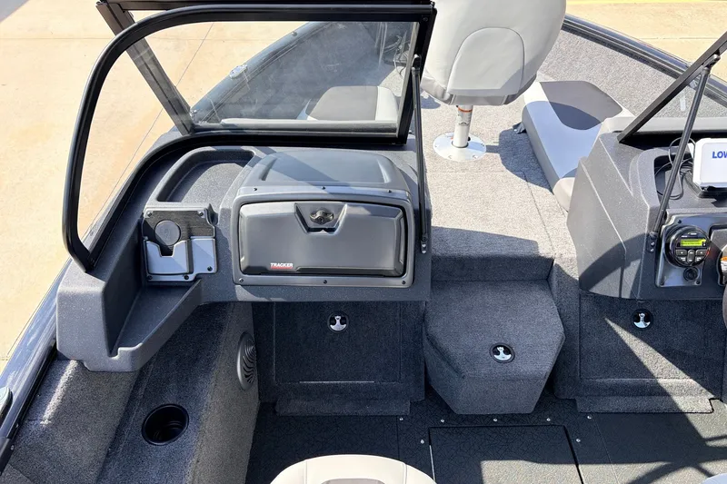Slide: The Image of Interior view of 2027 Tracker Pro Guide V-175 Combo boat, featuring seating and dashboard controls. - 23