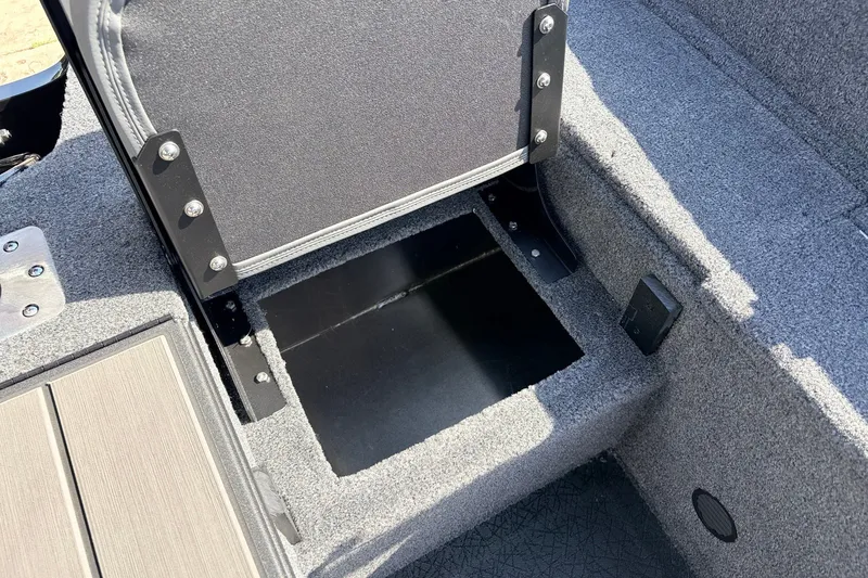 Slide: The Image of 2027 Tracker Pro Guide V-175 Combo boat seat storage compartment, open and carpeted. - 37
