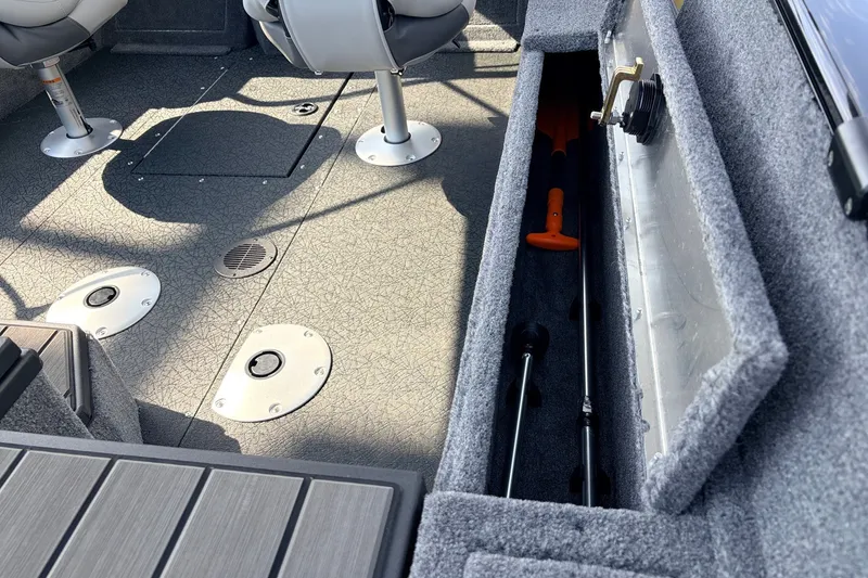 Slide: The Image of Interior of 2027 Tracker Pro Guide V-175 Combo boat with storage compartment open. - 49