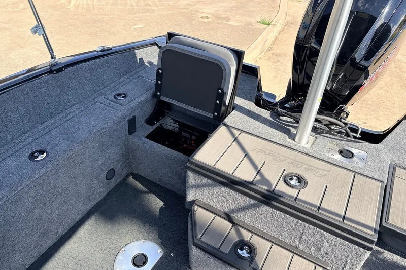 Slide: The Image of 2027 Tracker Pro Guide V-175 Combo boat interior with storage compartments and motor. - 40