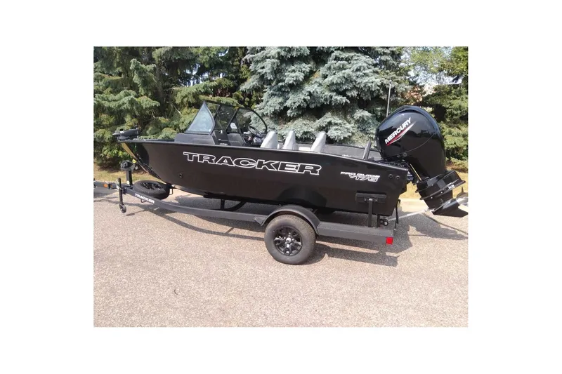 The Image of 2027 Tracker Pro Guide V-175 Combo boat on trailer, parked outdoors. - 0