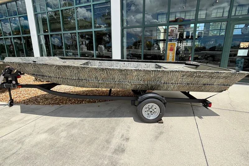 The Image of 2027 Tracker Grizzly 1648 Utility boat on trailer, parked outside showroom. - 0