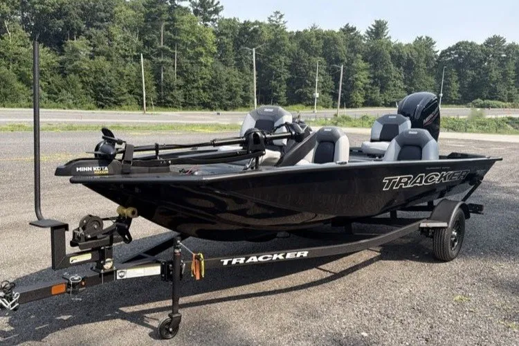 The Image of 2027 Tracker Pro Team 175 boat on trailer, parked outdoors. - 0