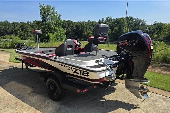 Slide: The Image of 2027 Nitro Z18 XL boat with powerful outboard motor, parked outdoors on a sunny day. - 3