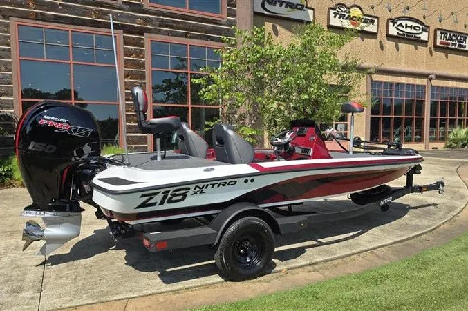 Slide: The Image of 2027 Nitro Z18 XL boat with Mercury engine, parked outside dealership. - 2