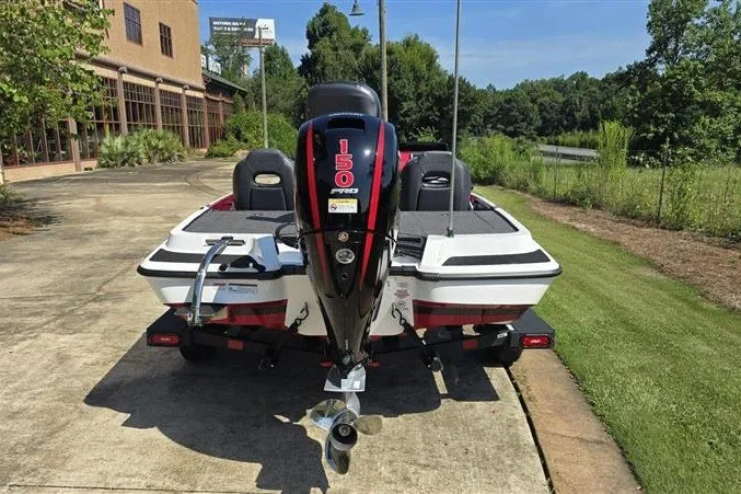 Slide: The Image of 2027 Nitro Z18 XL boat with 150 HP engine, parked on a driveway. - 4