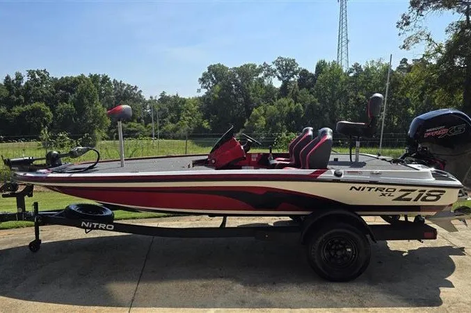 The Image of 2027 Nitro Z18 XL fishing boat on trailer, parked outdoors. - 0