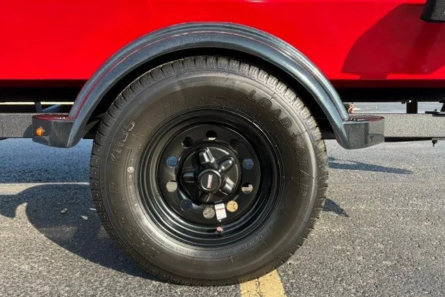 Slide: The Image of Trailer wheel of 2027 Tracker Bass Tracker Classic XL, black rim, red body. - 14