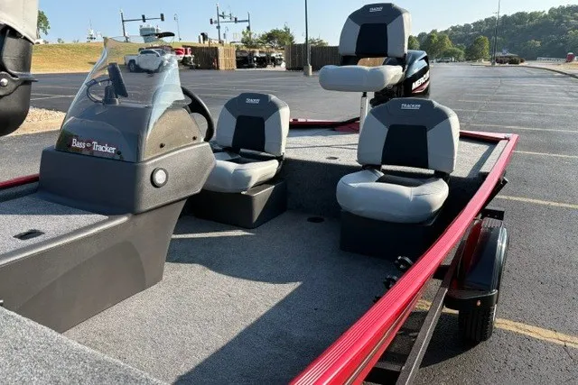 Slide: The Image of 2027 Tracker Bass Tracker Classic XL boat with seating, parked in a lot. - 19