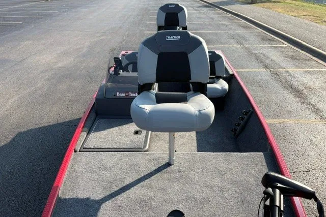 Slide: The Image of 2027 Tracker Bass Tracker Classic XL boat with gray seating in a parking lot. - 23