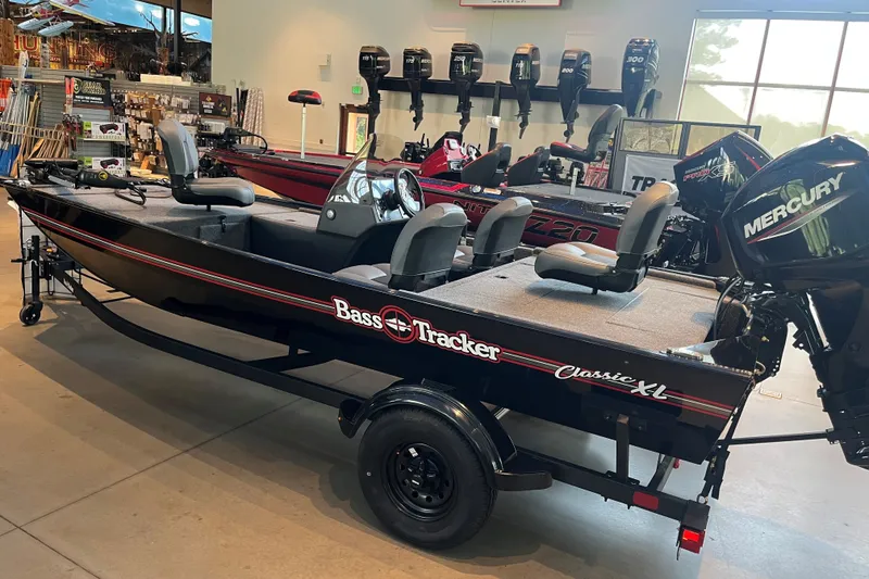 The Image of 2027 Tracker Bass Tracker Classic XL boat displayed indoors with Mercury engine. - 0