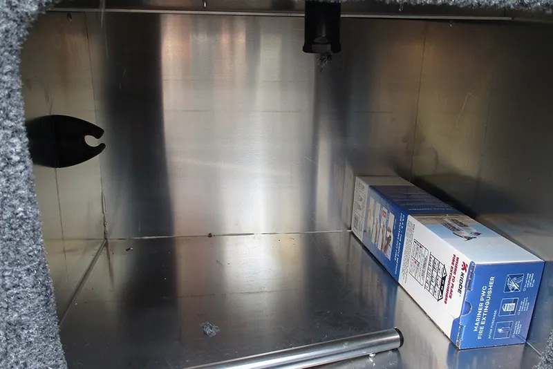 Slide: The Image of Storage compartment of 2027 Tracker Bass Tracker Classic XL with fire extinguisher box. - 17