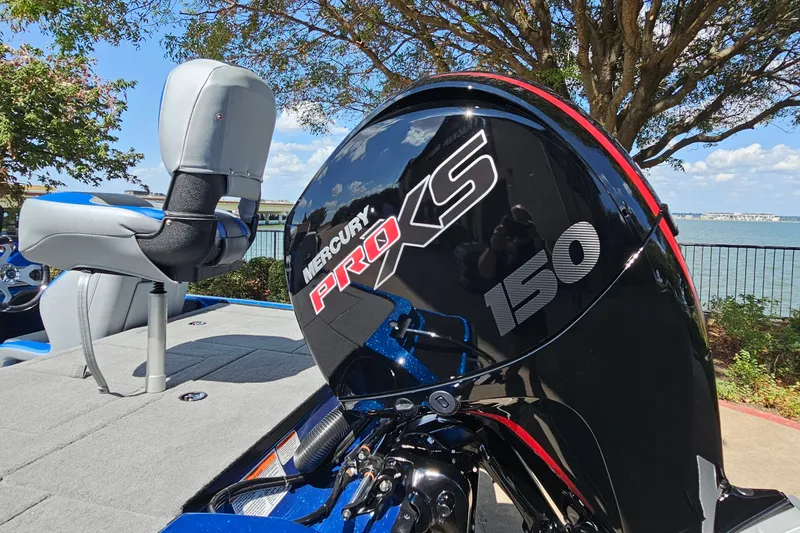 Slide: The Image of 2027 Nitro Z18 XL Pro boat with Mercury Pro XS 150 engine by a lake. - 9
