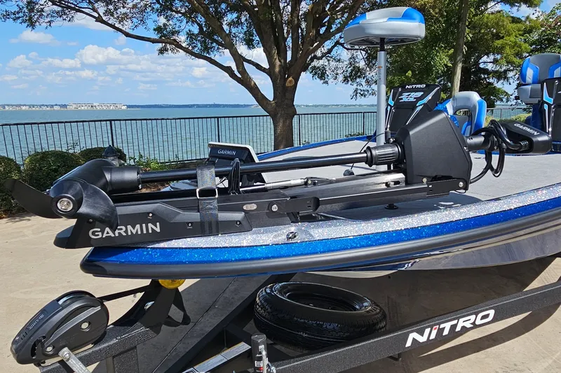 Slide: The Image of 2027 Nitro Z18 XL Pro boat with Garmin equipment, parked by a scenic lakeside. - 2