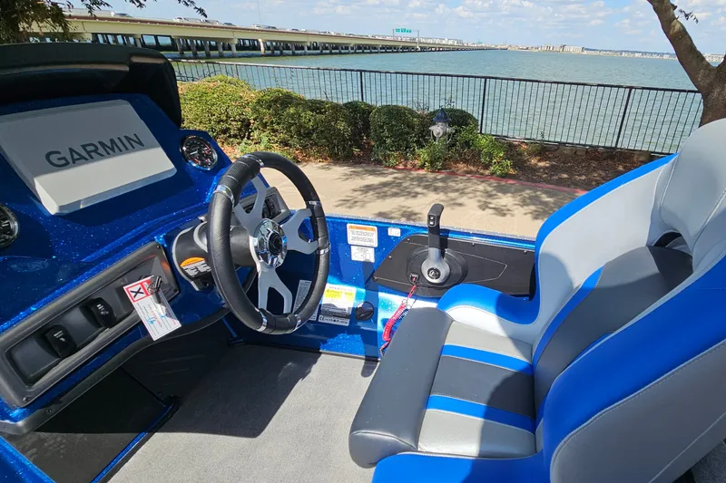 Slide: The Image of Interior of a 2027 Nitro Z18 XL Pro boat with Garmin navigation system by a waterfront. - 11