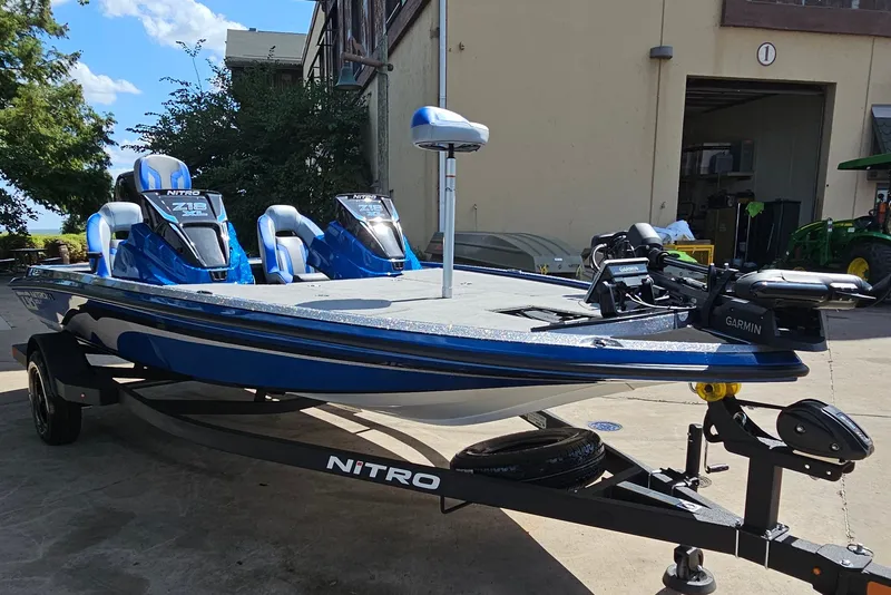 Slide: The Image of 2027 Nitro Z18 XL Pro fishing boat with Garmin equipment, parked outdoors. - 4