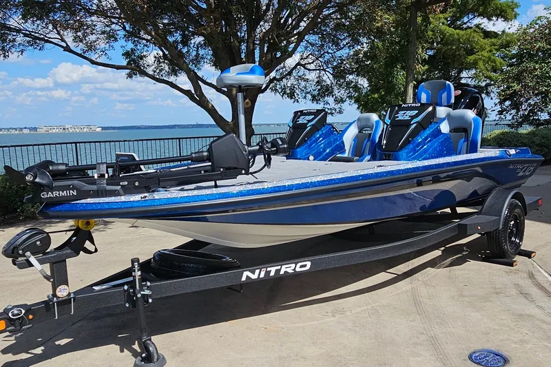 Slide: The Image of 2027 Nitro Z18 XL Pro boat on trailer by lakeside, featuring Garmin equipment. - 1