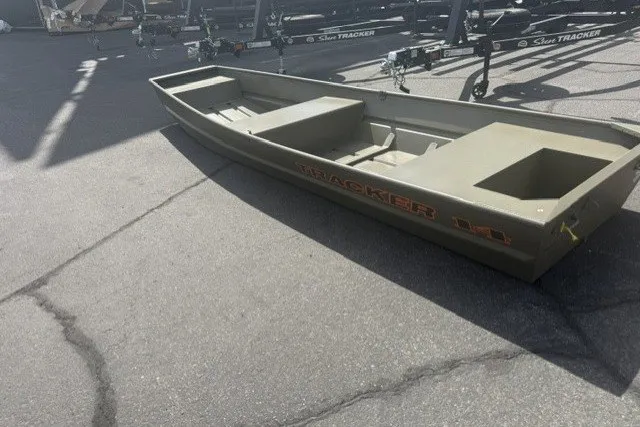 The Image of 2027 Tracker Grizzly 14 Jon boat on pavement, showcasing durable design and spacious interior. - 0