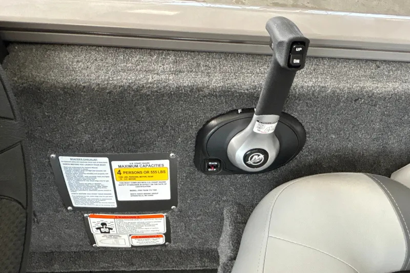 Slide: The Image of Control panel of 2027 Tracker Pro Team 175 boat with capacity and warning labels. - 16