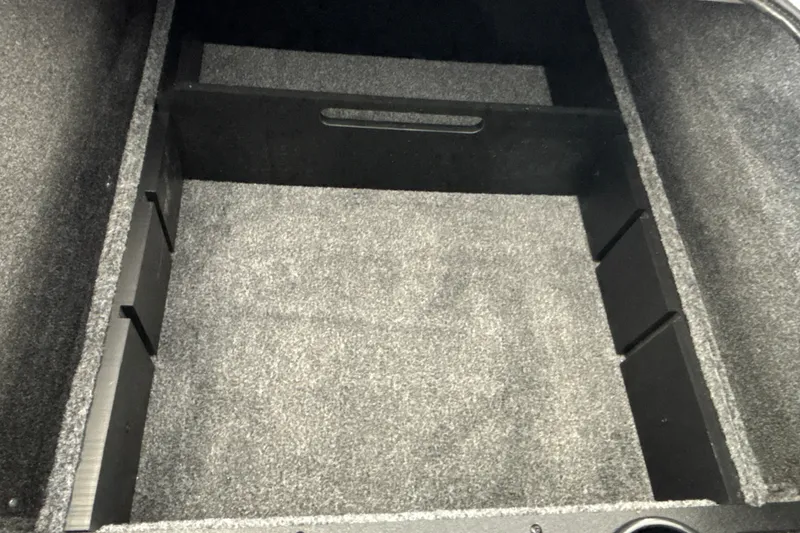 Slide: The Image of Carpeted storage compartment in a 2027 Tracker Pro Team 175 boat. - 27