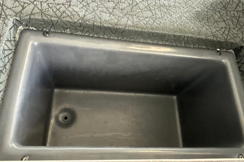Slide: The Image of Empty storage compartment in a 2027 Tracker Pro Team 175 boat. - 25