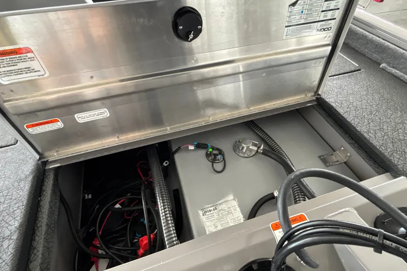 Slide: The Image of 2027 Tracker Pro Team 175 boat interior showing wiring and storage compartment. - 30