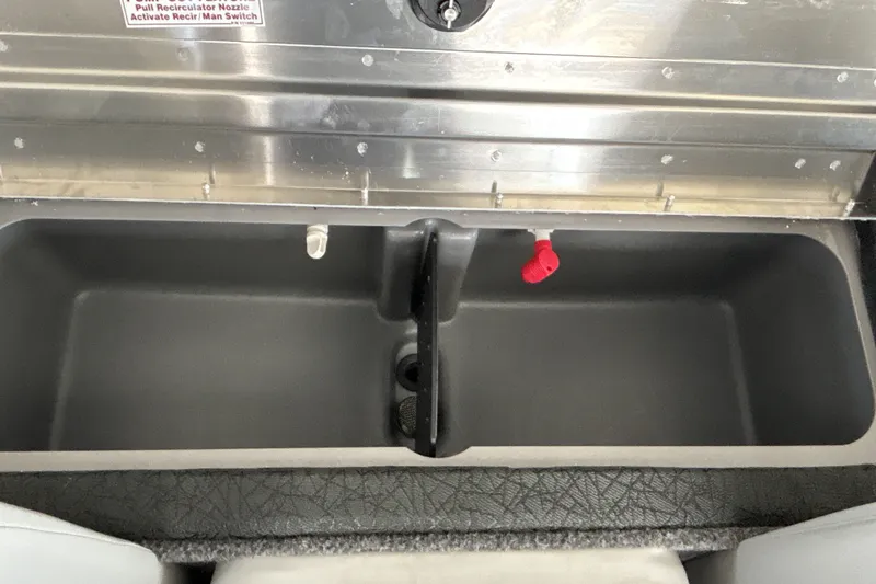 Slide: The Image of Livewell compartment in a 2027 Tracker Pro Team 175 boat, featuring recirculator nozzle and switch. - 23