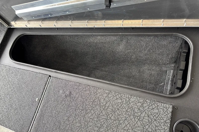 Slide: The Image of Storage compartment in 2027 Tracker Pro Team 175 boat, featuring carpeted interior. - 28