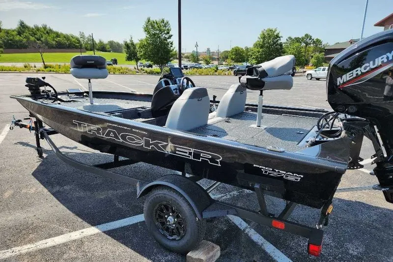 The Image of 2027 Tracker Pro Team 175 fishing boat with Mercury engine in parking lot. - 0