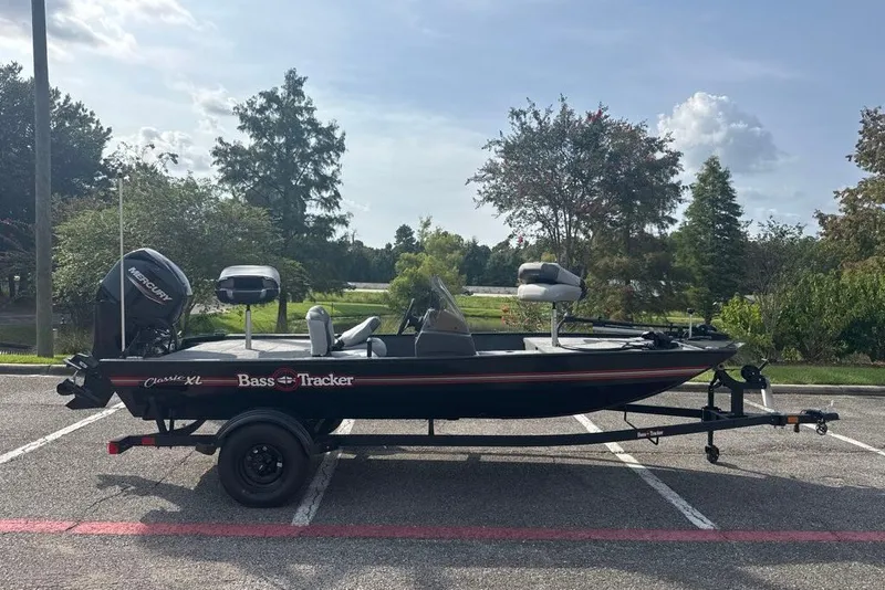 The Image of 2027 Tracker Bass Tracker Classic XL boat on trailer in parking lot. - 0