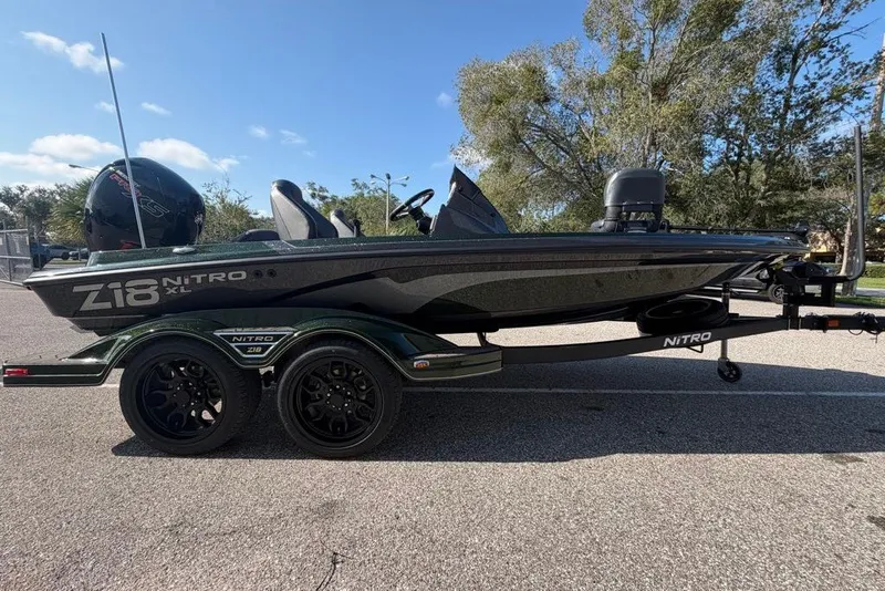 Slide: The Image of 2027 Nitro Z18 XL boat on trailer, parked outdoors under clear sky. - 4
