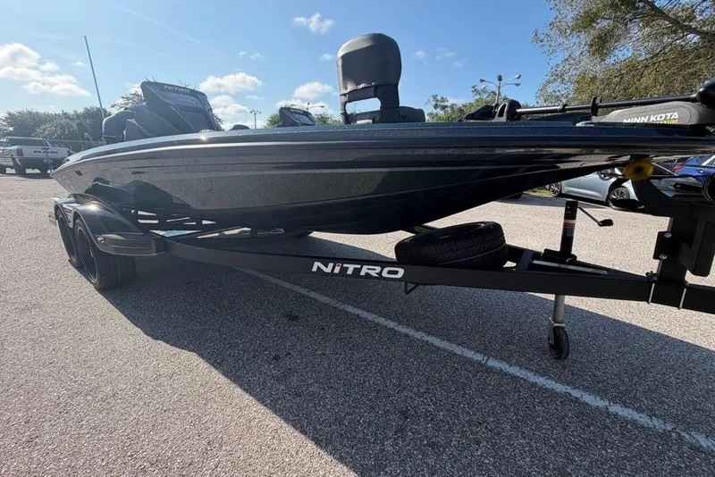 Slide: The Image of 2027 Nitro Z18 XL boat on trailer in parking lot, sunny day. - 2