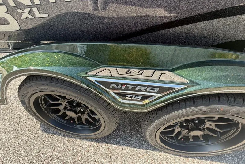 Slide: The Image of 2027 Nitro Z18 XL trailer with black wheels and green metallic finish. - 3